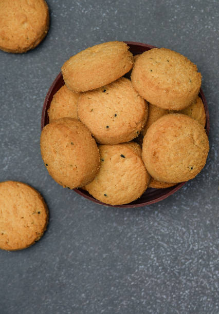 istock biscuits isolated on dark background.Atta biscuit, cookies, white flour biscuit - Indian cooking 1274846366