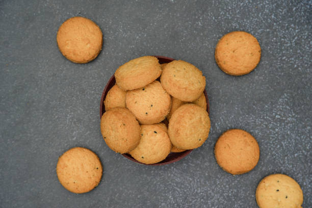istock biscuits isolated on dark background.Atta biscuit, cookies, white flour biscuit - Indian cooking 1274846660