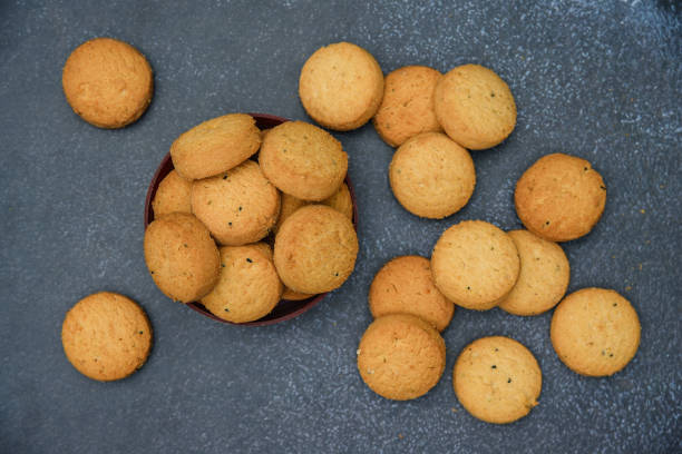 istock biscuits isolated on dark background.Atta biscuit, cookies, white flour biscuit - Indian cooking 1274847709