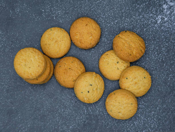 istock biscuits isolated on dark background.Atta biscuit, cookies, white flour biscuit - Indian cooking 1274848126