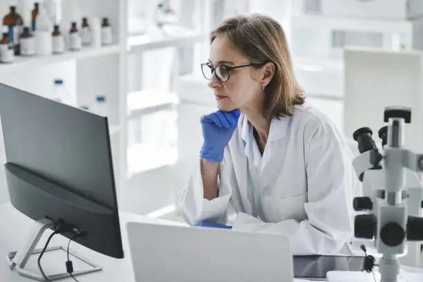 Shot of mature scientist working on a computer in a lab