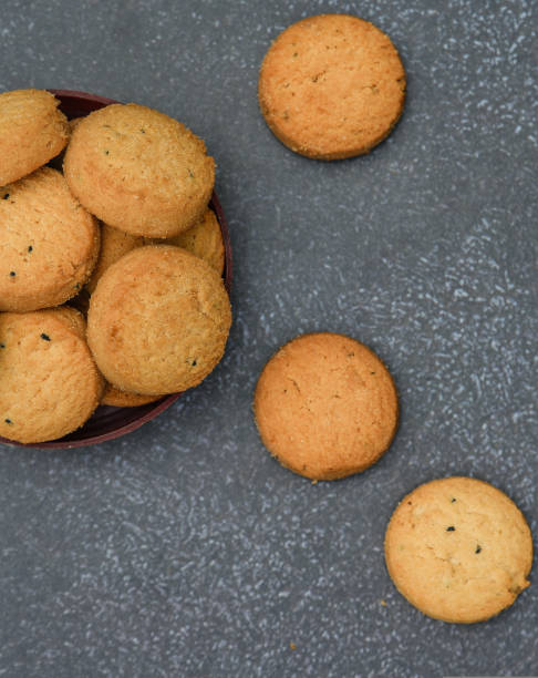 istock biscuits isolated on dark background.Atta biscuit, cookies, white flour biscuit - Indian cooking 1274849234