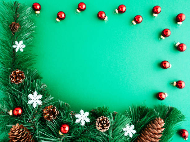 istock Bright new year or Christmas composition, flat lay, copyspace. Festive frame of Christmas tree, Christmas decorations, cones and Christmas toys on a green background, copyspace, top view 1274849245