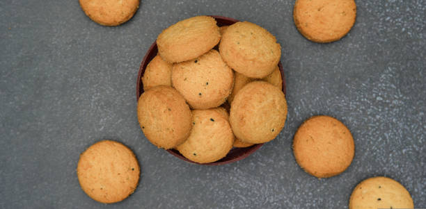 istock biscuits isolated on dark background.Atta biscuit, cookies, white flour biscuit - Indian cooking 1274849269