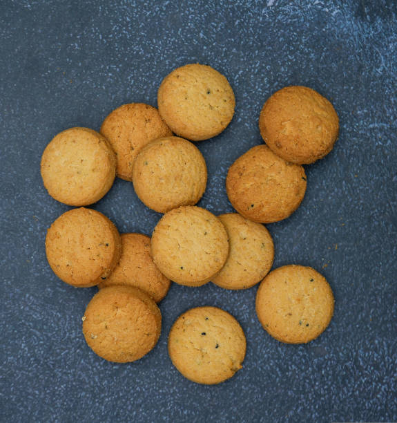 istock biscuits isolated on dark background.Atta biscuit, cookies, white flour biscuit - Indian cooking 1274849293