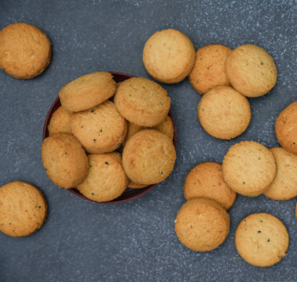 istock biscuits isolated on dark background.Atta biscuit, cookies, white flour biscuit - Indian cooking 1274849303