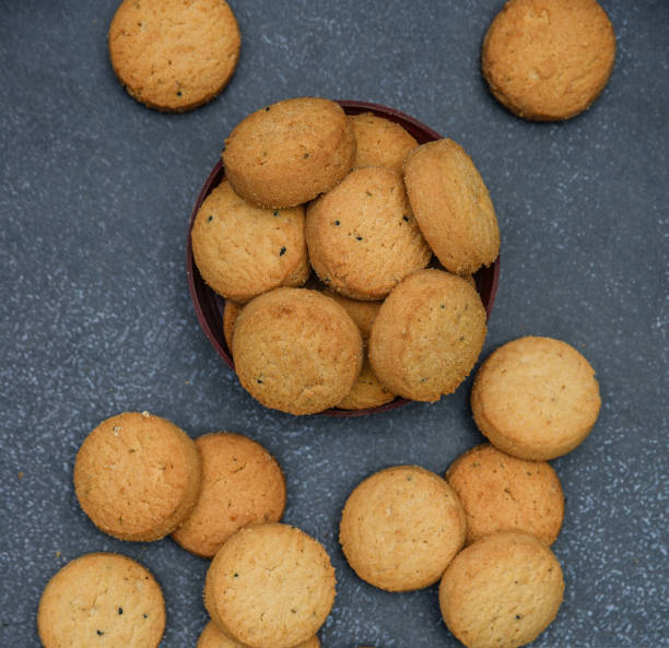 istock biscuits isolated on dark background.Atta biscuit, cookies, white flour biscuit - Indian cooking 1274849317