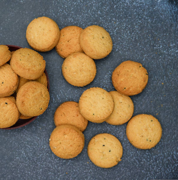 istock biscuits isolated on dark background.Atta biscuit, cookies, white flour biscuit - Indian cooking 1274849320