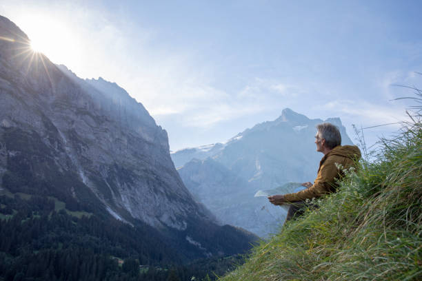 istock Hiker relaxes in alpine meadow, at sunrise 1274855981