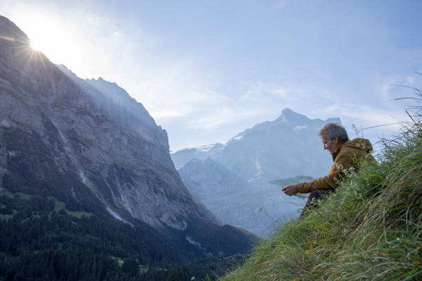 istock Hiker relaxes in alpine meadow, at sunrise 1274857305