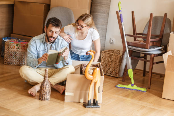 istock Married couple unpacking cardboard boxes at new home. 1274866809