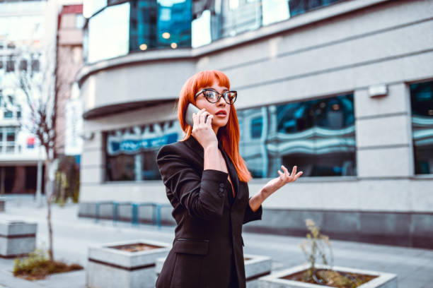 istock Elegant Female CEO Arguing Via Telephone On Her Way To Work 1274868385