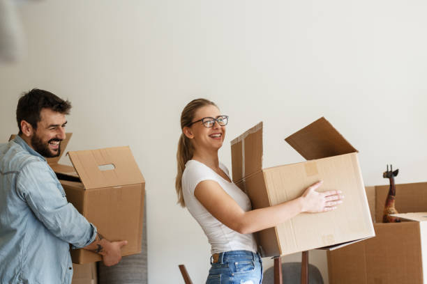 istock Young married couple moving into new home. 1274869015