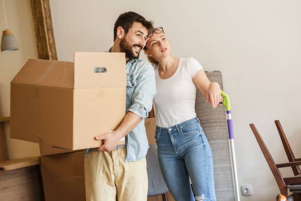 istock Young married couple moving into new home. 1274869029