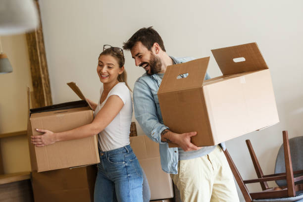 istock Young married couple moving into new home. 1274869079