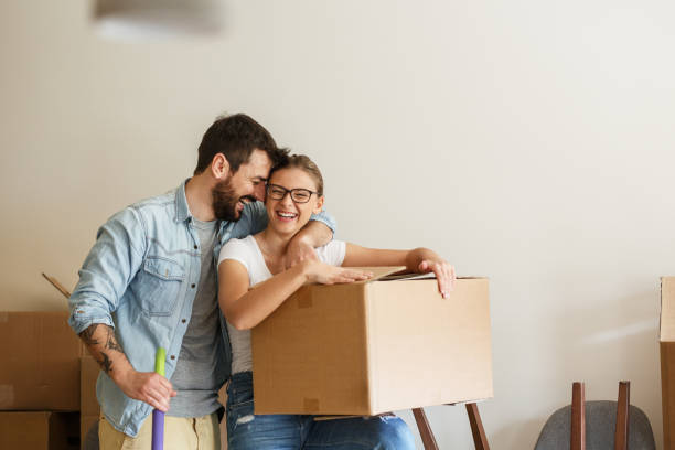 istock Young married couple moving into new home. 1274869318