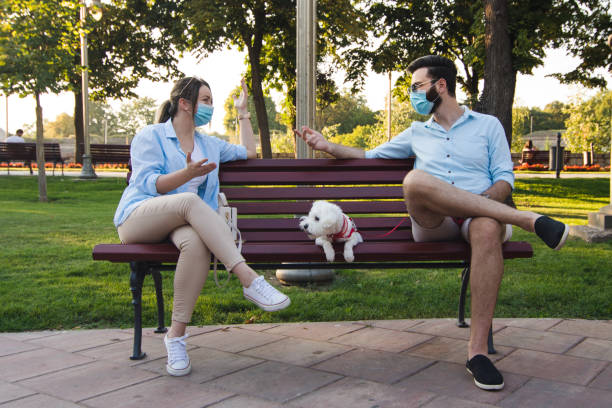 Couple distances themselves in pandemic stock photo