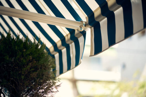 istock Blue And White Retractable Awning On Greek Patio 1274886939