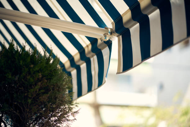 Blue And White Retractable Awning On Greek Patio stock photo