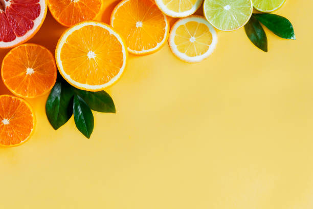 istock Oranges and citruses isolated on yellow background 1274898748