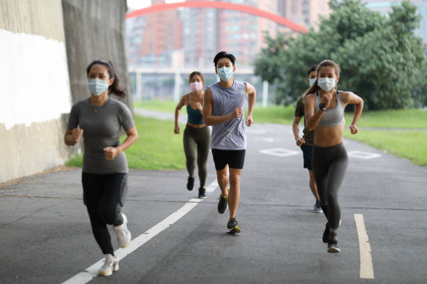 istock Young team jogging in city park 1274900185