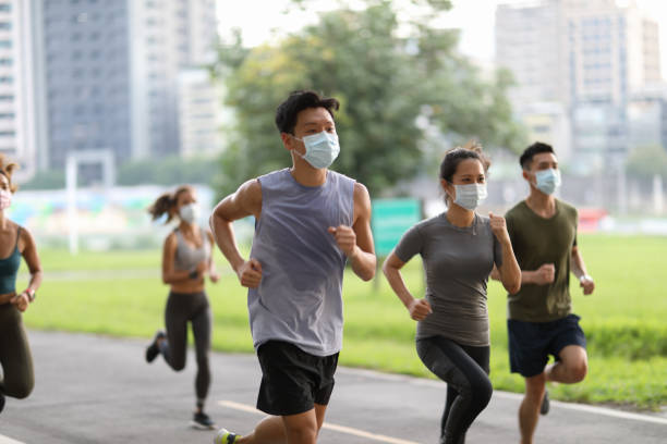istock Young team jogging in city park 1274901958