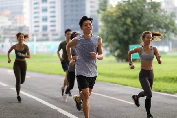 istock Young team jogging in city park 1274902568