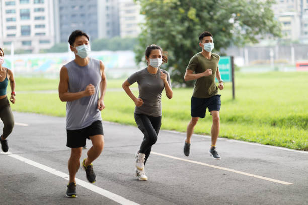 istock Young team jogging in city park 1274903626