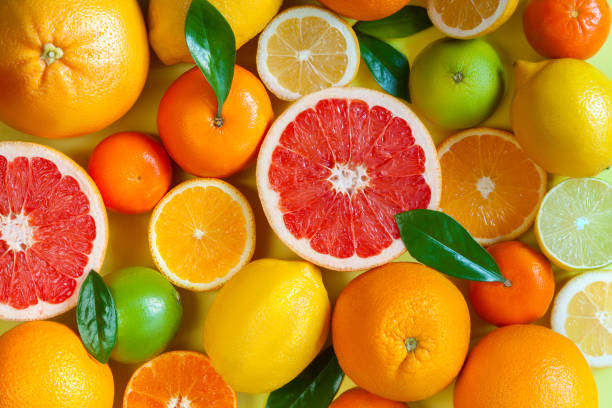 istock Oranges and citruses isolated on yellow background 1274904191