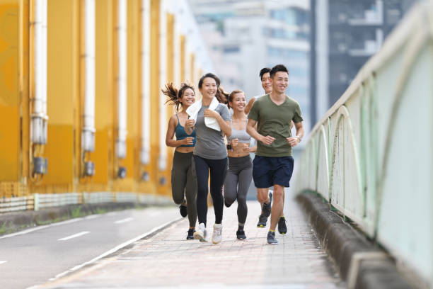 istock Young team jogging on city bridge 1274904228