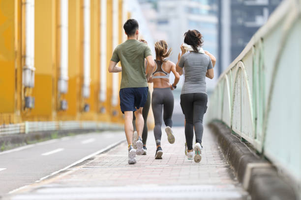 istock Young team jogging on city bridge 1274904851