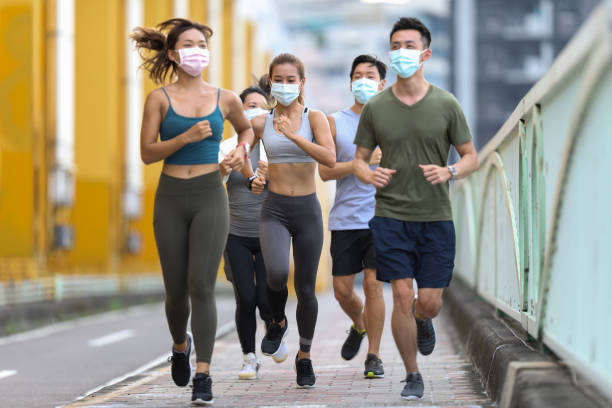 istock Young team jogging on city bridge 1274907394