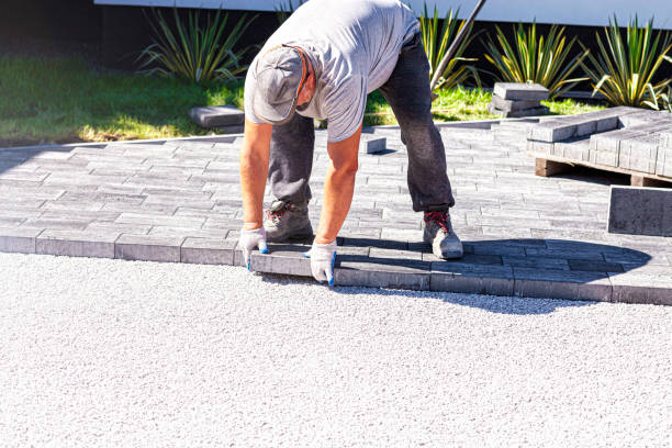istock Paver arranges cement paving stones 1274920333