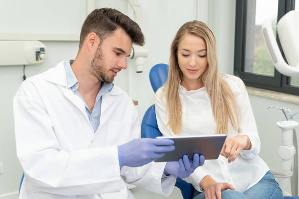 istock Dentist showing teeth x-ray on tablet screen 1274929118