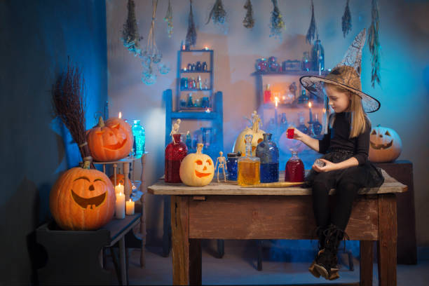 istock beautiful little witch with Halloween decorations 1274930014