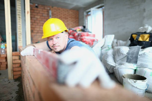 istock Concentrated builder taking measurements of brick surface 1274938312