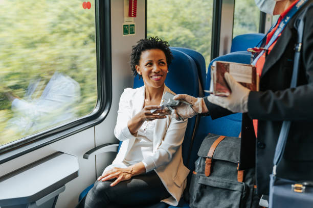 Checking ticket Beautiful Afro-American woman travelling by train, having her ticket checked transport conductor stock pictures, royalty-free photos & images