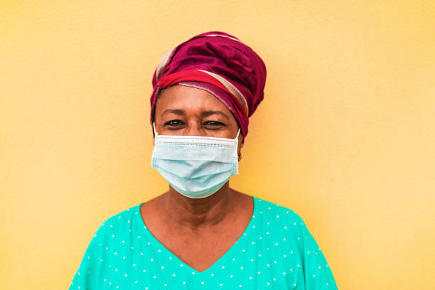 Senior african woman wearing face protective mask during coronavirus outbreak