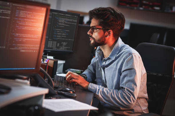 Male programmer working on new project. Male programmer working on new project. He working late at night at the office. web designer photos stock pictures, royalty-free photos & images
