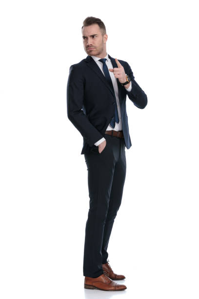 istock Side view of upset businessman looking over shoulder and blaming 1274958891