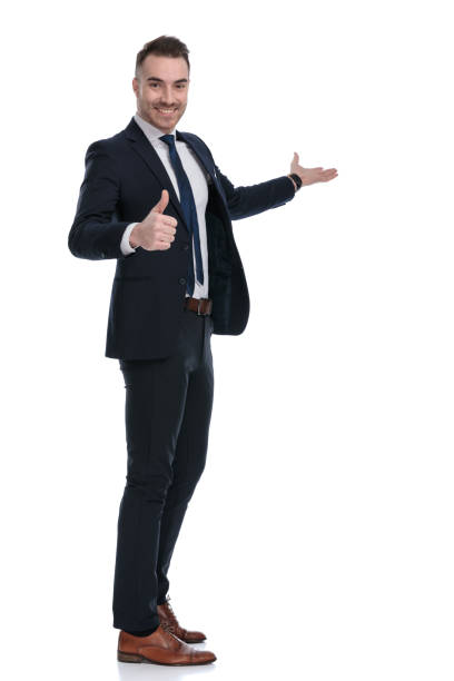 istock Side view of smiling businessman gesturing ok and presenting 1274958931