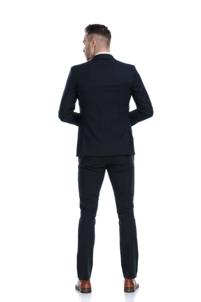 istock Back view of mysterious businessman looking over shoulder 1274958991