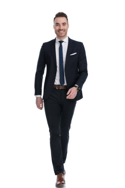 istock Positive businessman smiling and wearing suit while stepping 1274959073