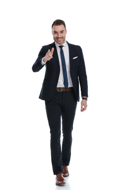 istock Happy businessman pointing forward and smiling while stepping 1274959255