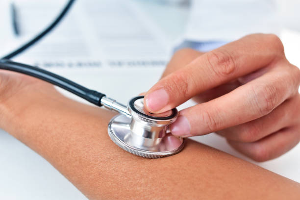 istock doctor auscultating the pulse with an stethoscope 1274959662