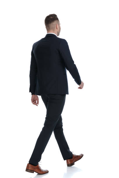 istock Side rear view of positive wearing suit and moving 1274959879