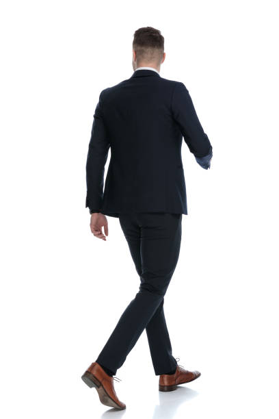 istock Side rear view of confident wearing suit and stepping 1274959896
