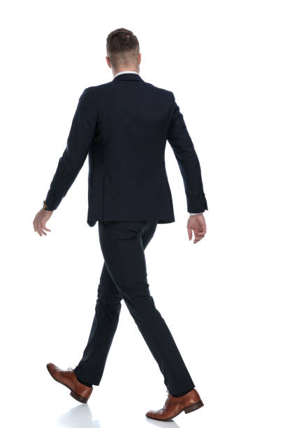 istock Side rear view of confident wearing suit and walking 1274959927