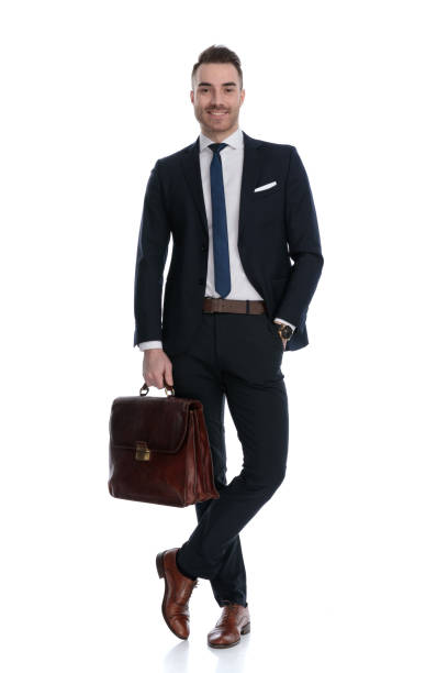 istock Happy businessman holding briefcase and smiling 1274959989