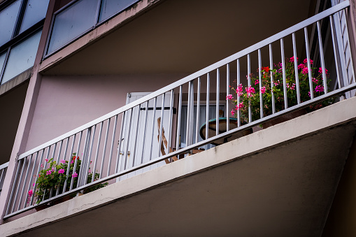 Balconies decorated with flower pots, cast iron railings, stone columns, retro style street light, Bierzo area, León province, Castilla y Leon, Spain.